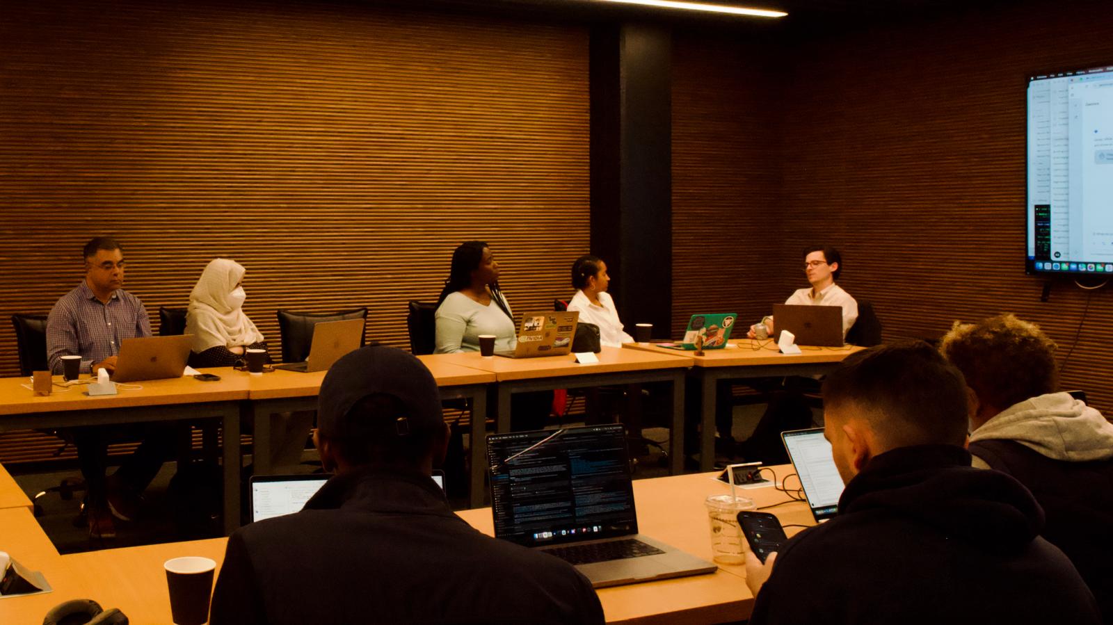 Attendees collaborating on laptops